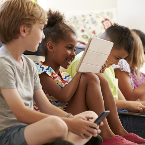 Kids learning together on tablets